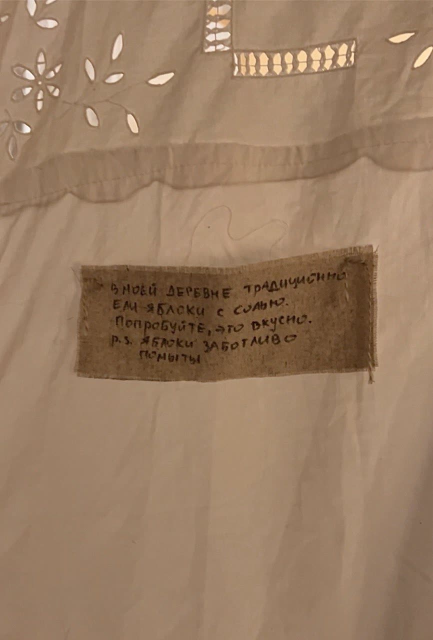 Handwritten note on linen: in my village people traditionally ate apples with salt, try it