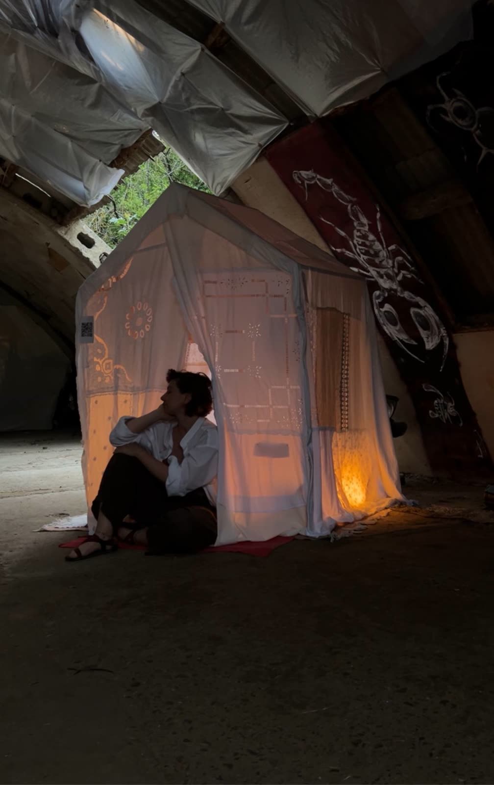 A visitor sitting at the entrance of the textile house