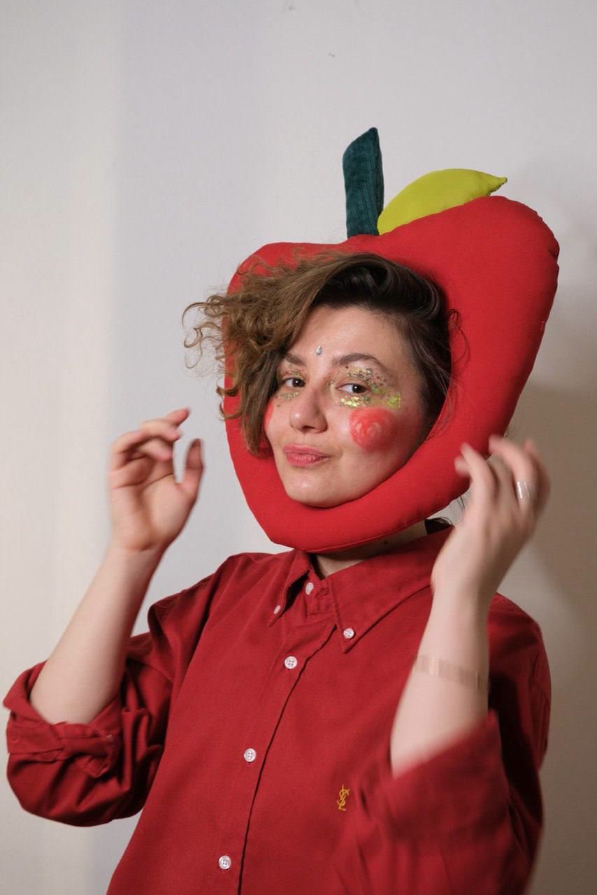 Ekaterina Beliaeva in a red apple hat